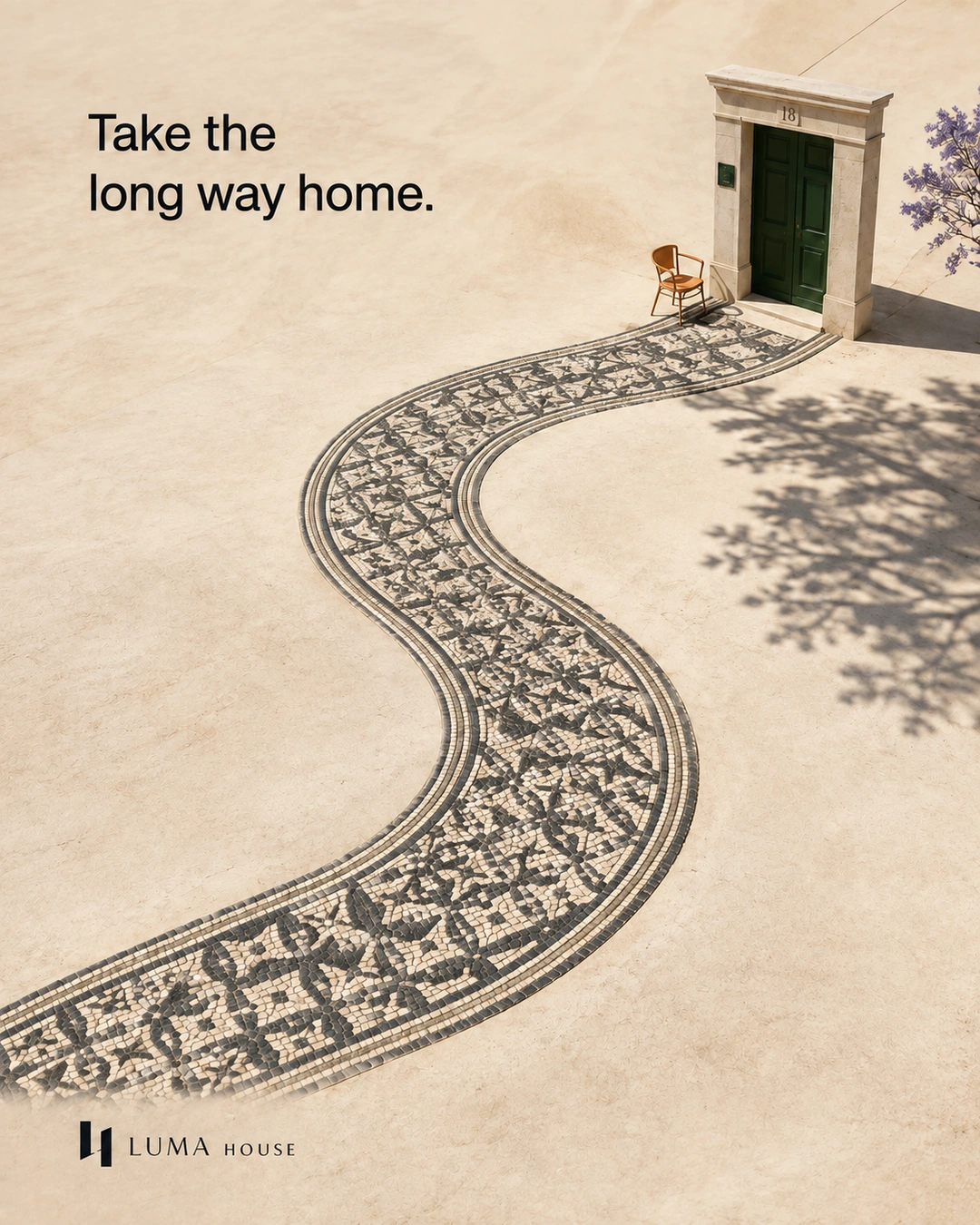 An S-shaped strip of Portuguese paving leads to a green door.